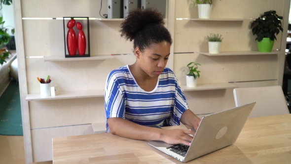 Mixed Race Woman Works With Computer At The Office.