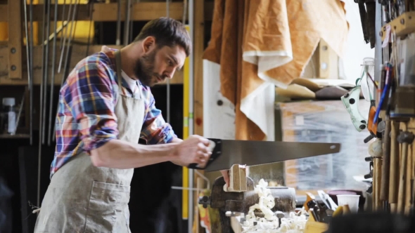 Carpenter Working With Saw And Wood At Workshop 8