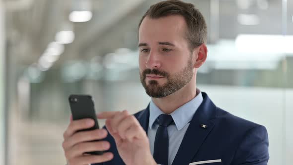 Portrait of Businessman Using Smartphone 