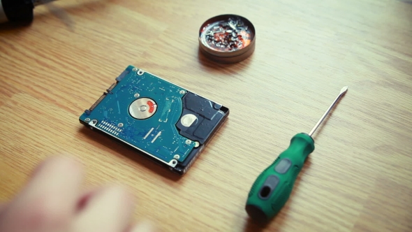 Repairman Unfixing a Computer Motherboard. 