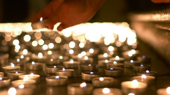 Woman Placing Her Candle On The Floor alt