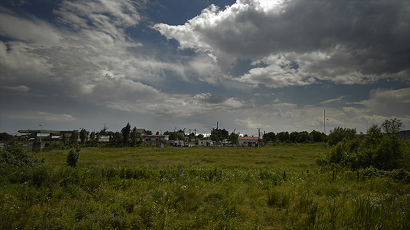 Dramatic Clouds Over the Green Field