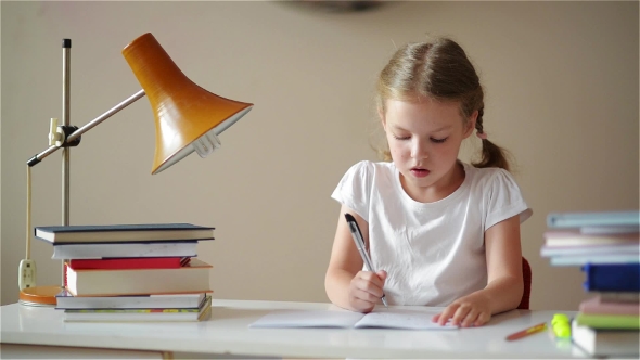 Schoolgirl Doing Homework And Preparing For Exams