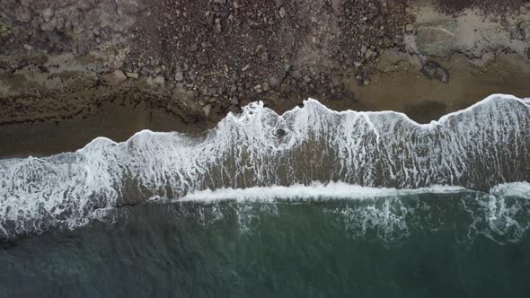 Aerial View From Above on Calm Azure Sea and Volcanic Rocky Shores