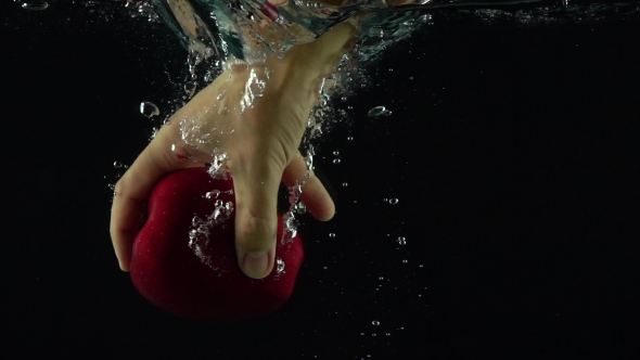 Man Hand Reaches And Grabs Red Apple Floating Under Water Super  Shot