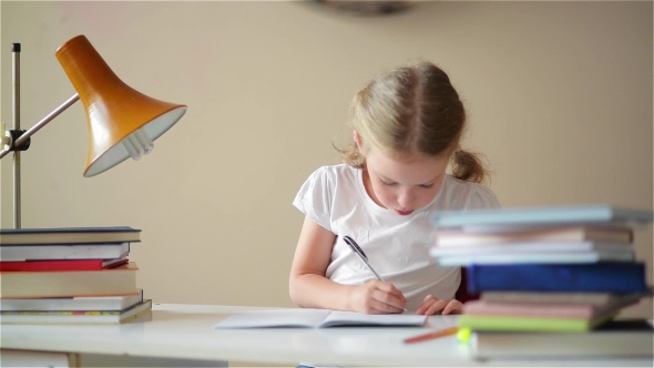 Little Schoolgirl Learns Lessons, Thoughtful Child Doing Homework