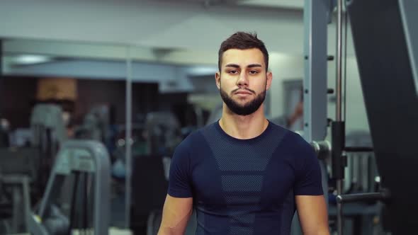 Athlete Walking in Gym Among Equipment