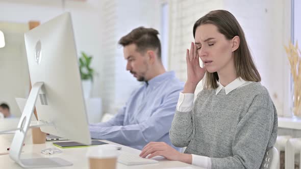 Tired Creative Female Professional Having Headache in Office