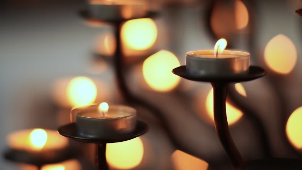 Candle Flame At Night In Church. Abstract Glowing Background. alt