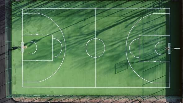Empty Green Basketball Court in the Morning with Beautiful Soft Shadows  Top Aerial View