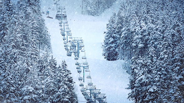Chairlift on Mountainside in Snowfall