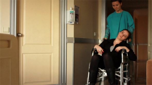 Nurse Carrying Patient on a Wheelchair at Hospital 2