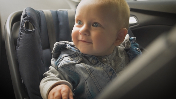 Little Boy Sitting in a Special Car Seat