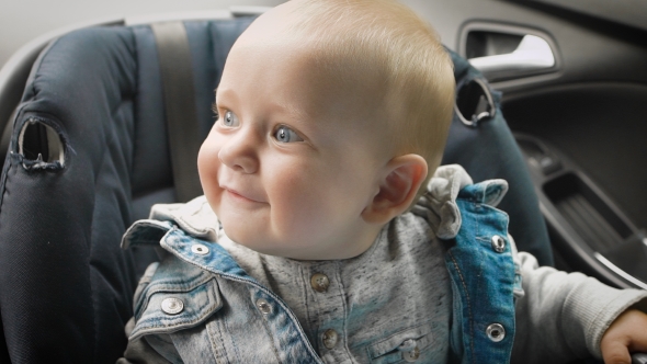Little Boy Sitting in a Special Car Seat
