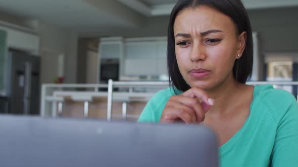 African american woman using laptop while working from home