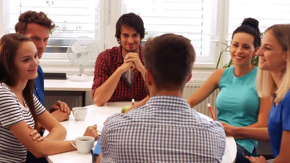 Male and female business executives interacting with each other