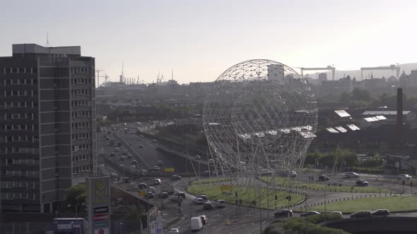 Aerial flyover of Belfast and the Rise Sculpture near the Falls Road and Westlink Motorway