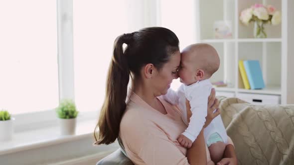 Happy Young Mother with Little Baby Son at Home