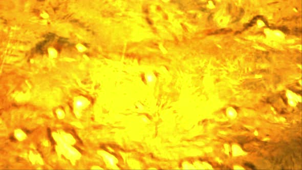 Motion graphic of a golden water flowing effect for background footage usage