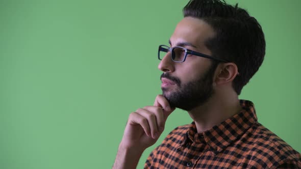 Closeup Profile View of Happy Young Bearded Persian Hipster Man Thinking