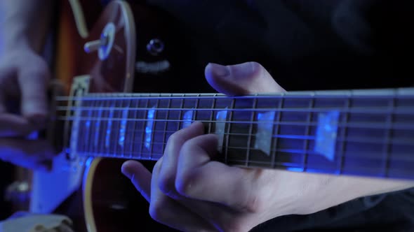 Hands playing chords on guitar strings. Music guitar online lessons. Music instruments.