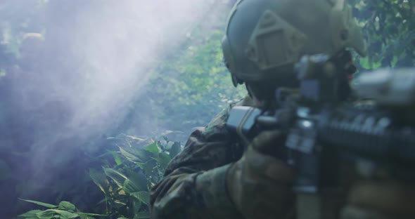 Silhouette of the Fully Equipped Soldier Moving Through Smokey Forest