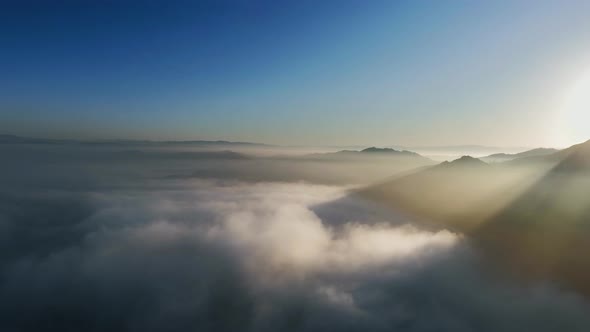 Aerial view of sunlight near clouds and mountain peaks in Malibu Canyon, Monte Nido, California, USA