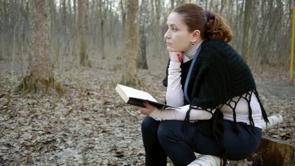 Girl Sitting In The Park And Thinks. 