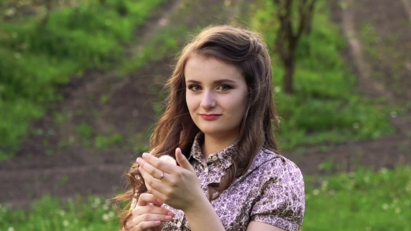 Young Model With Dandelion In Hand Looking On a Camera