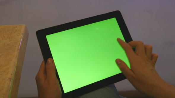 Female Hands Using Tablet Pc With Green Screen In Shopping Mall.