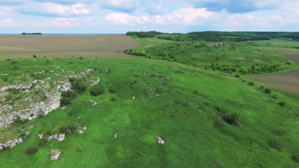 Aerial View Of Green Rocks, Hill And Fields