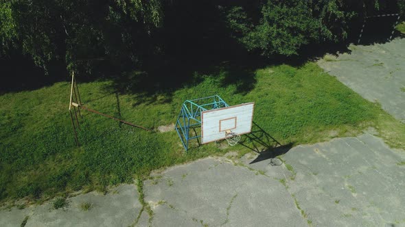 Old Basketball Backboard. Made From Boards. Peeling Paint And A Battered Basket