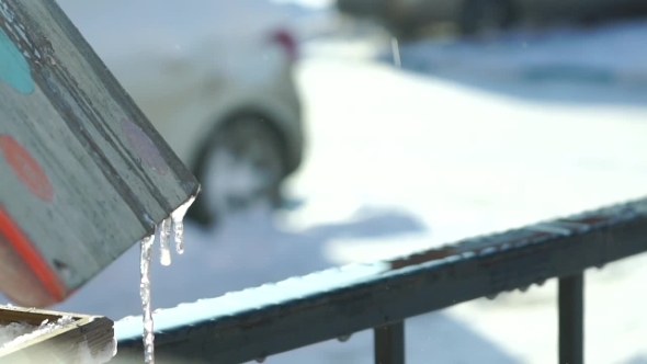 Drip Of Thawing Snow In Residential Area