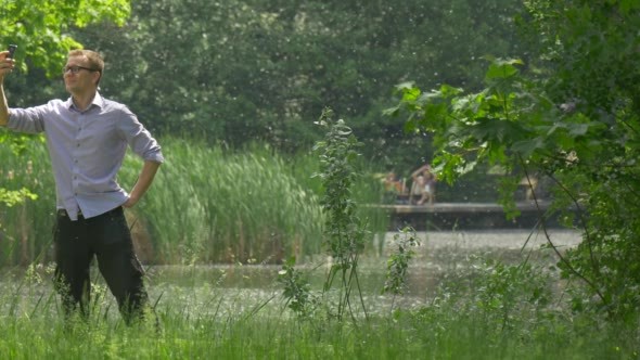 Man Taking Photo With Phone Cyclist is Riding