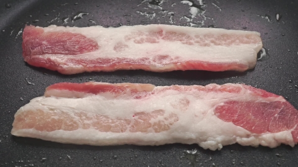 Two Horizontal Frying Bacon Slices