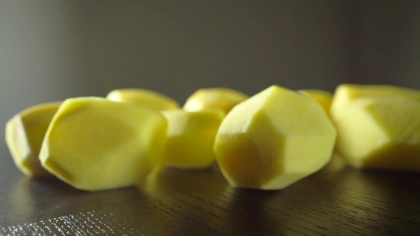 Peeled Yellow Potatoes And Woman Hand