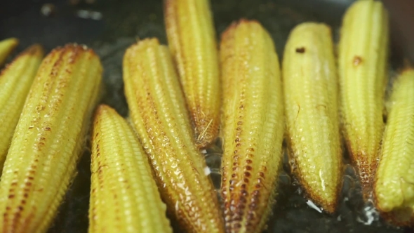  Shot Of Roasting Small Corn Cobs