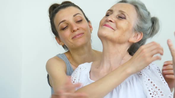 Adult Daughter is Hugging Her Senior Mother the Women are Laughing Together Sincere Family of