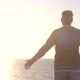 old man looking to the sunset and the sea with opened arms feeling free and happy - freedom - VideoHive Item for Sale