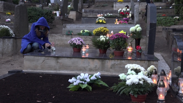 Girl Light Candle Lantern In Memory Of Husband Father In Cemetery. 