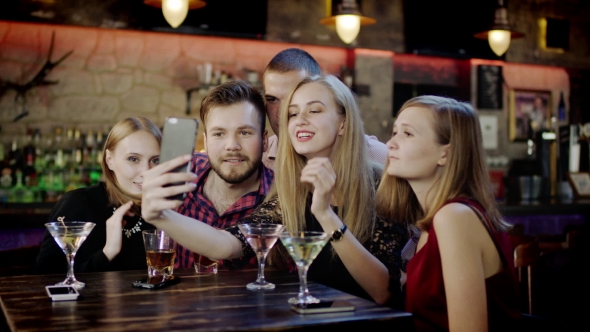 Company Of Young People Is Taking Selfie In The Bar