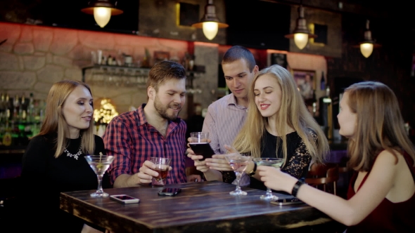 Company Of Young People Is Taking Selfie In The Bar