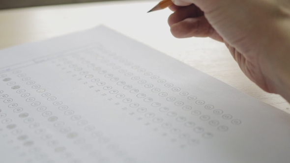 Student Filling Out Answers To a Test With a Pencil