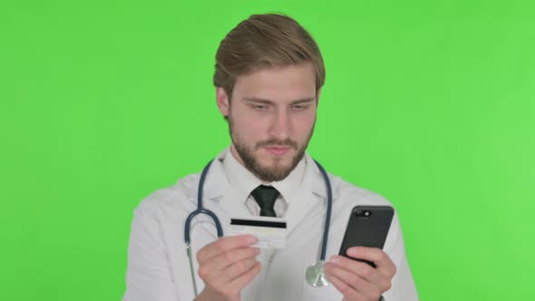 Online Shopping on Smartphone By Young Doctor on Green Background