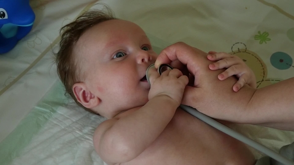 Doctor Exams Baby With Stethoscope