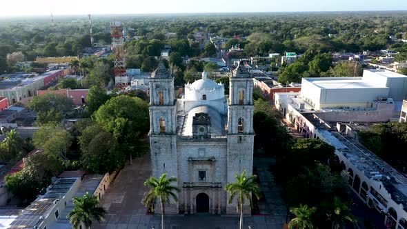 Aerial push in and tilt down onto the Cathedral de San Gervasio just after sunrise in Valladolid, Yu