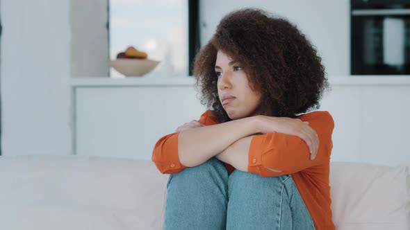 Alone Lonely Stressed African American Woman Sitting with Sad Problem at Home Couch Thinking About