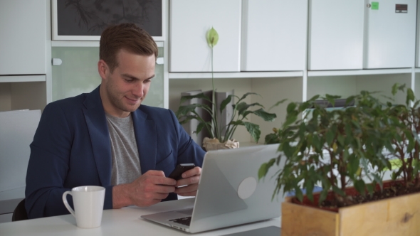 Handsome Man Texting Message On The Smartphone.