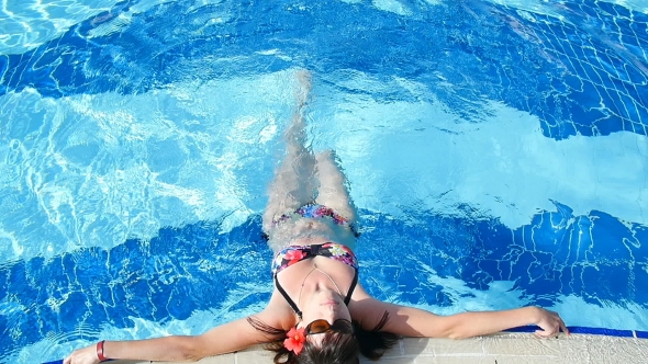 Beautiful Girl Relaxes In The Pool