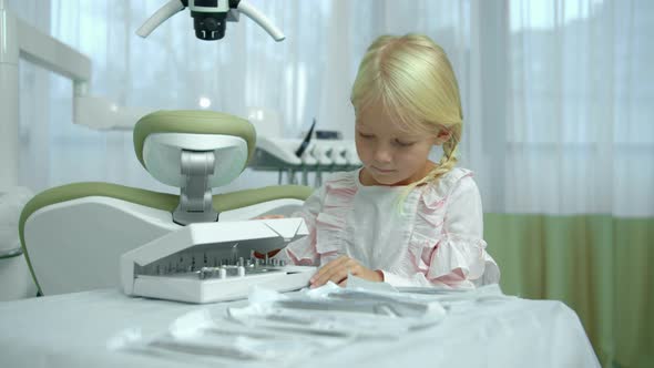 Little Girl Opens the Box with Instruments